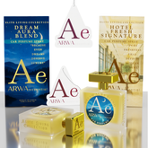 A perfume gift set from ARWA essential featuring two car perfume sprays in clear bottles with gold caps, two matching rectangular boxes, and two white hanging tags with the ARWA logo, all arranged on a reflective white surface.