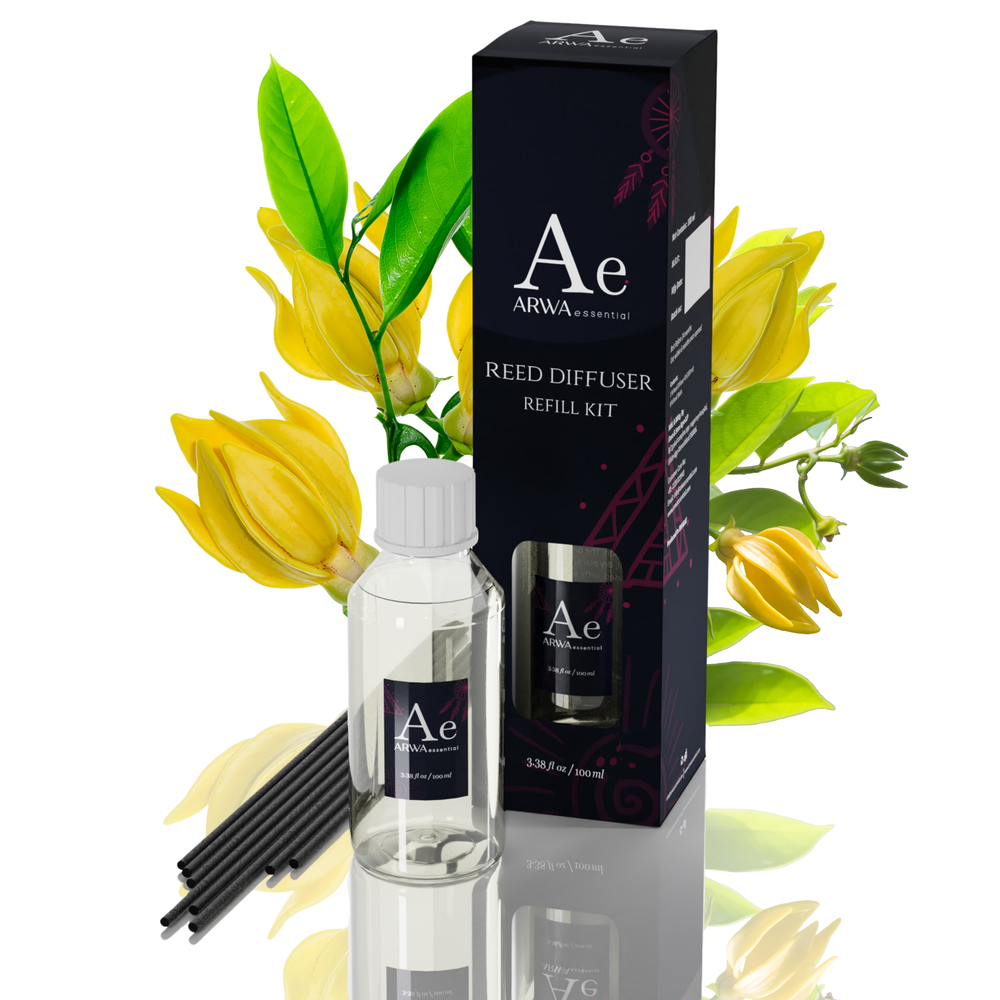 ARWA Essential Ylang-Ylang Reed Diffuser Refill Kit - 100ml fragrance oil bottle with 8 premium black reed sticks and packaging box, yellow ylang-ylang flowers in background