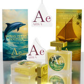 Oceanic Serenity Collection car perfume spray set by ARWA, featuring a translucent yellow bottle with a gold cap, a matching small gold box, a blue dolphin-themed card, a tropical sailboat card, and two white hanging tags with the ARWA logo.