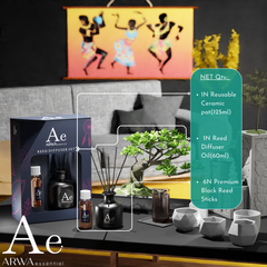 ARWA Essential Reed Diffuser Set contents - 1 reusable ceramic pot 125ml, 1 reed diffuser oil 60ml, 6 premium black reed sticks, displayed on living room table