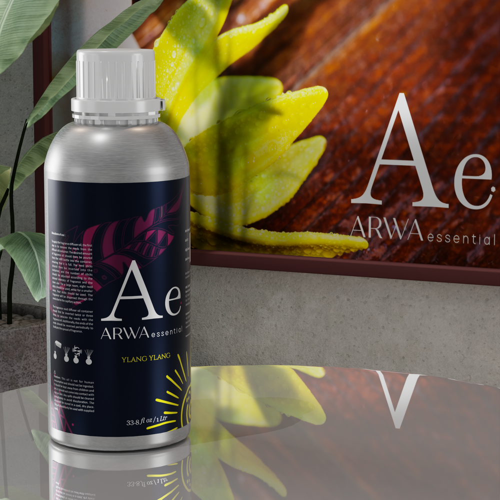 ARWA Essential Ylang-Ylang Aroma Diffuser Oil 1 Litre silver bottle displayed on table with ylang-ylang leaf home fragrance scene