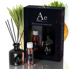ARWA Essential Lemongrass Reed Diffuser Set - black ceramic diffuser pot with reed sticks, fragrance oil bottle and refill bottle with packaging box, lemongrass stalks in background