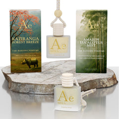 ARWA Essential Kaziranga Forest Breeze and Amazon Eucalyptus Mist 10ml hanging car perfume duo - packaging boxes and glass bottles with wooden caps on stone display